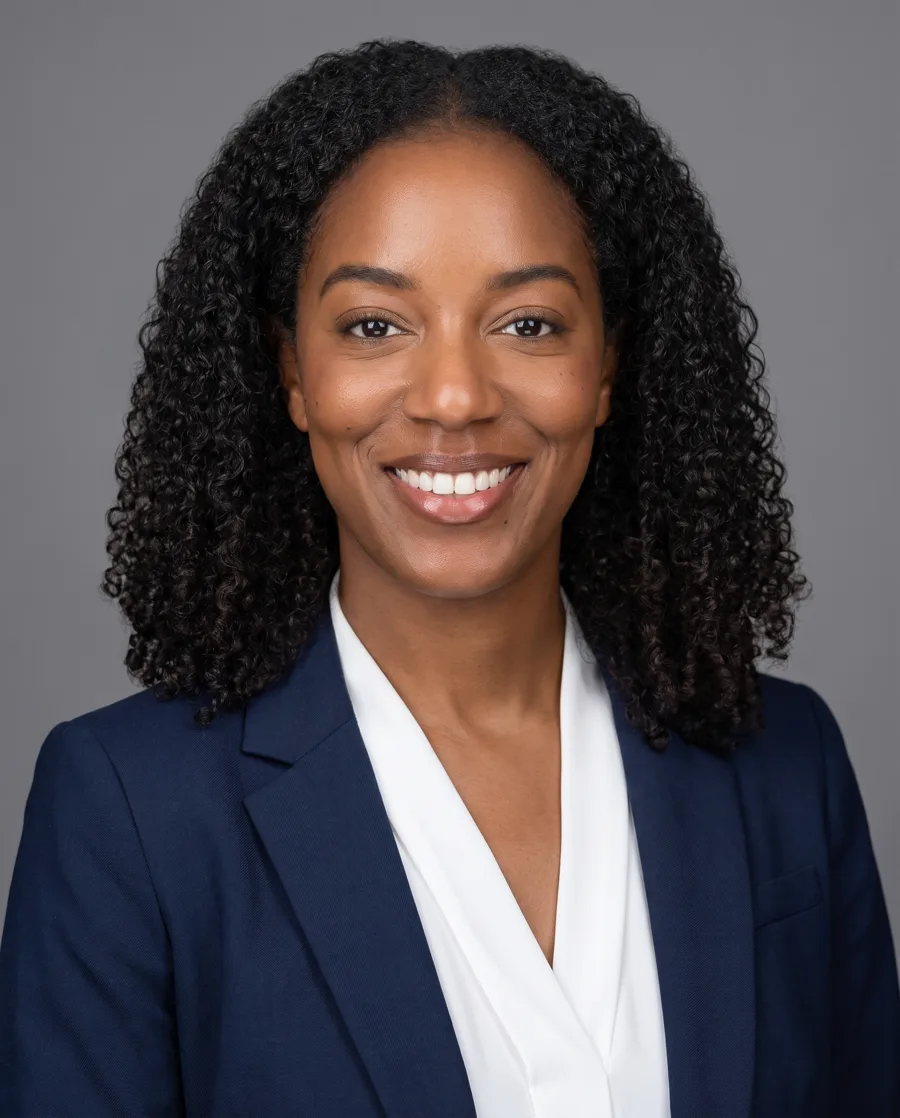 AI headshot from the reference photo: navy blazer, grey studio backdrop, for LinkedIn