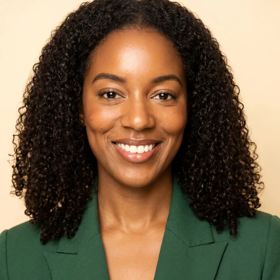 AI square headshot from the same photo: dark green blazer on a cream background
